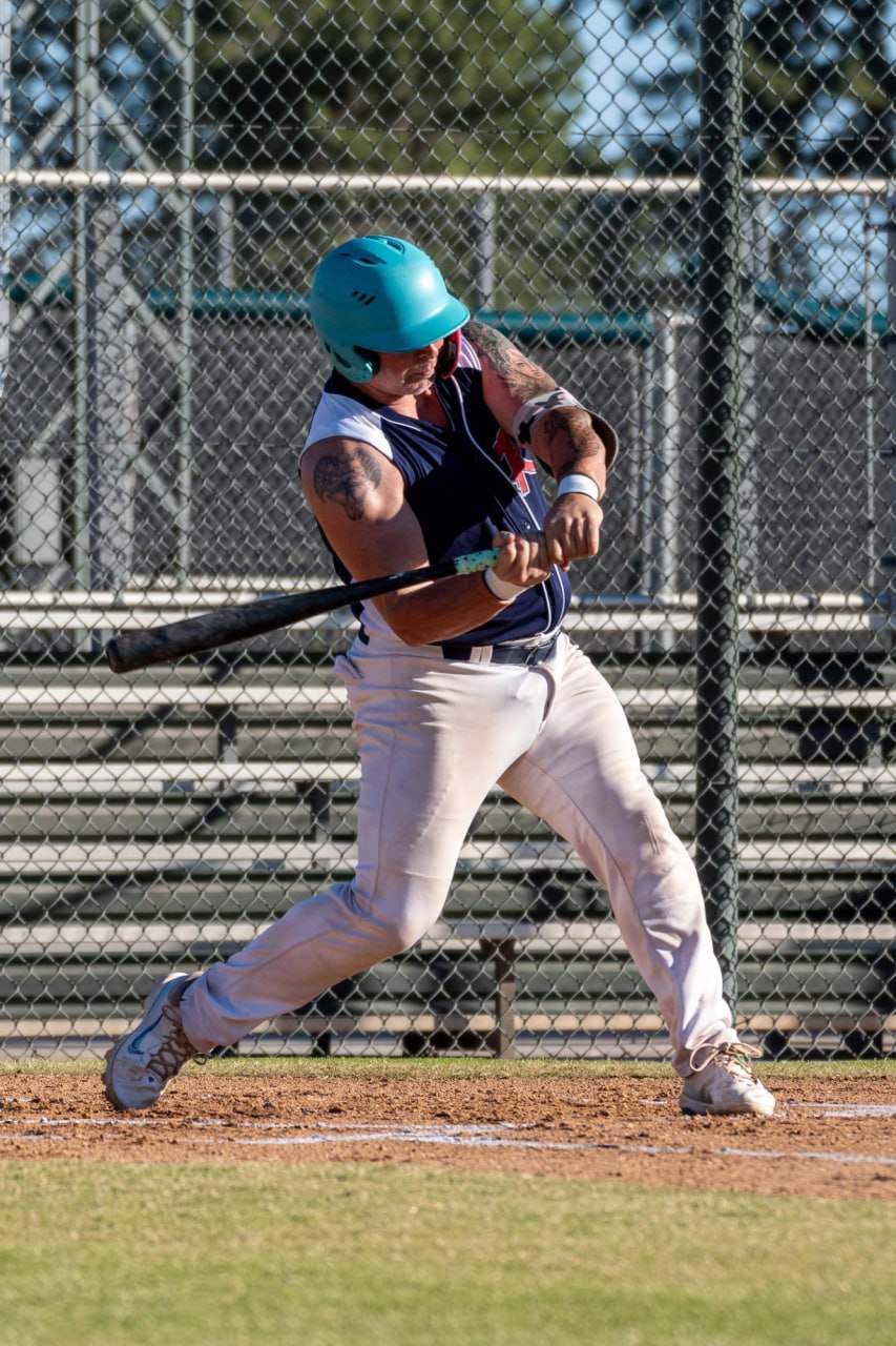 Coach Crosby in the batter's box mid-swing