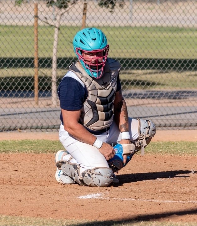 Coach Crosby in catcher's gear at home plate